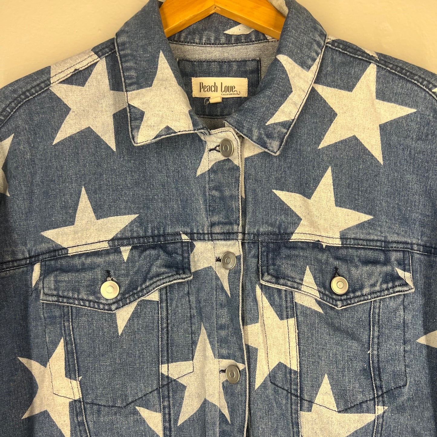 Close-up of chest pockets, button placket, and star print details