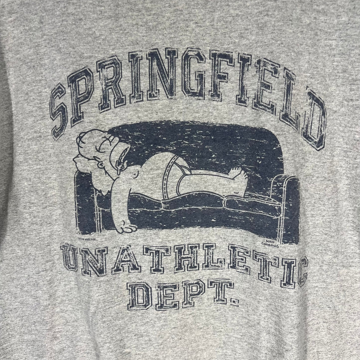 Close-up of Simpsons Springfield Unathletic Dept graphic with Homer Simpson on couch