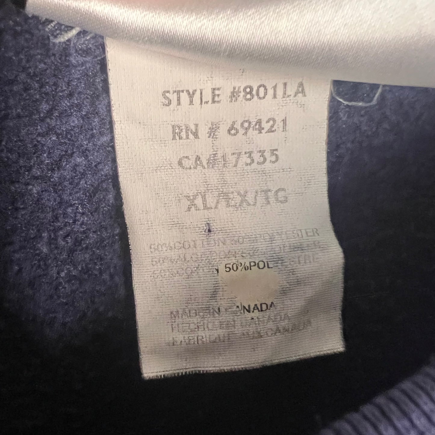 Interior tag showing fabric content, size XL, and origin (Made in Canada)