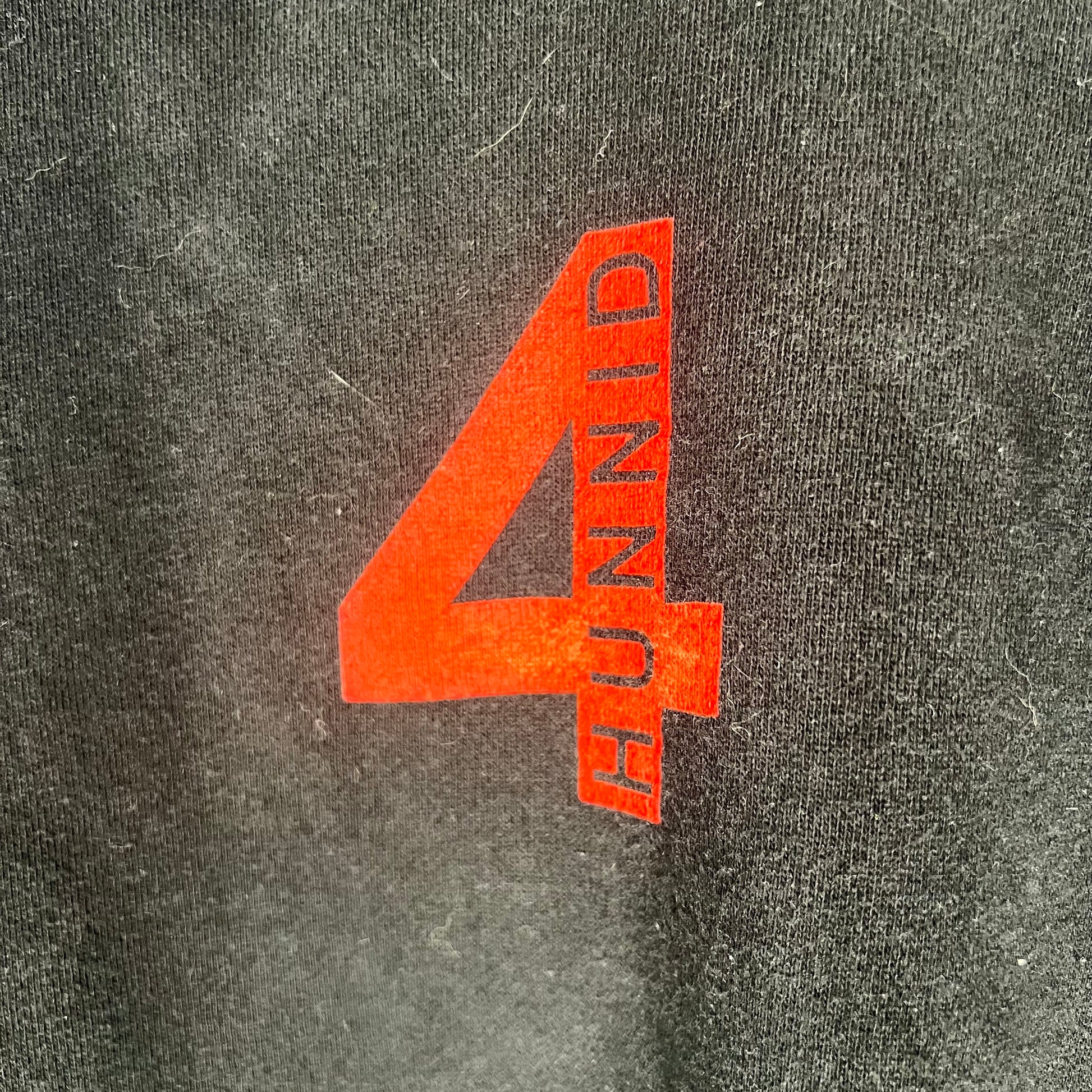 Close-up of red “4Hunnid” chest logo