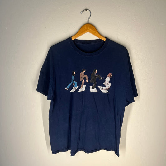 Front view of navy Abbey Road parody T-shirt with illustrated crosswalk graphic.
