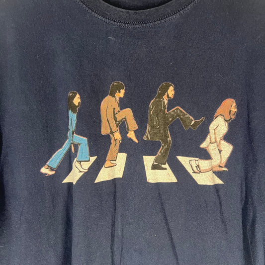 Close-up of Abbey Road parody graphic featuring cartoon band members crossing the street