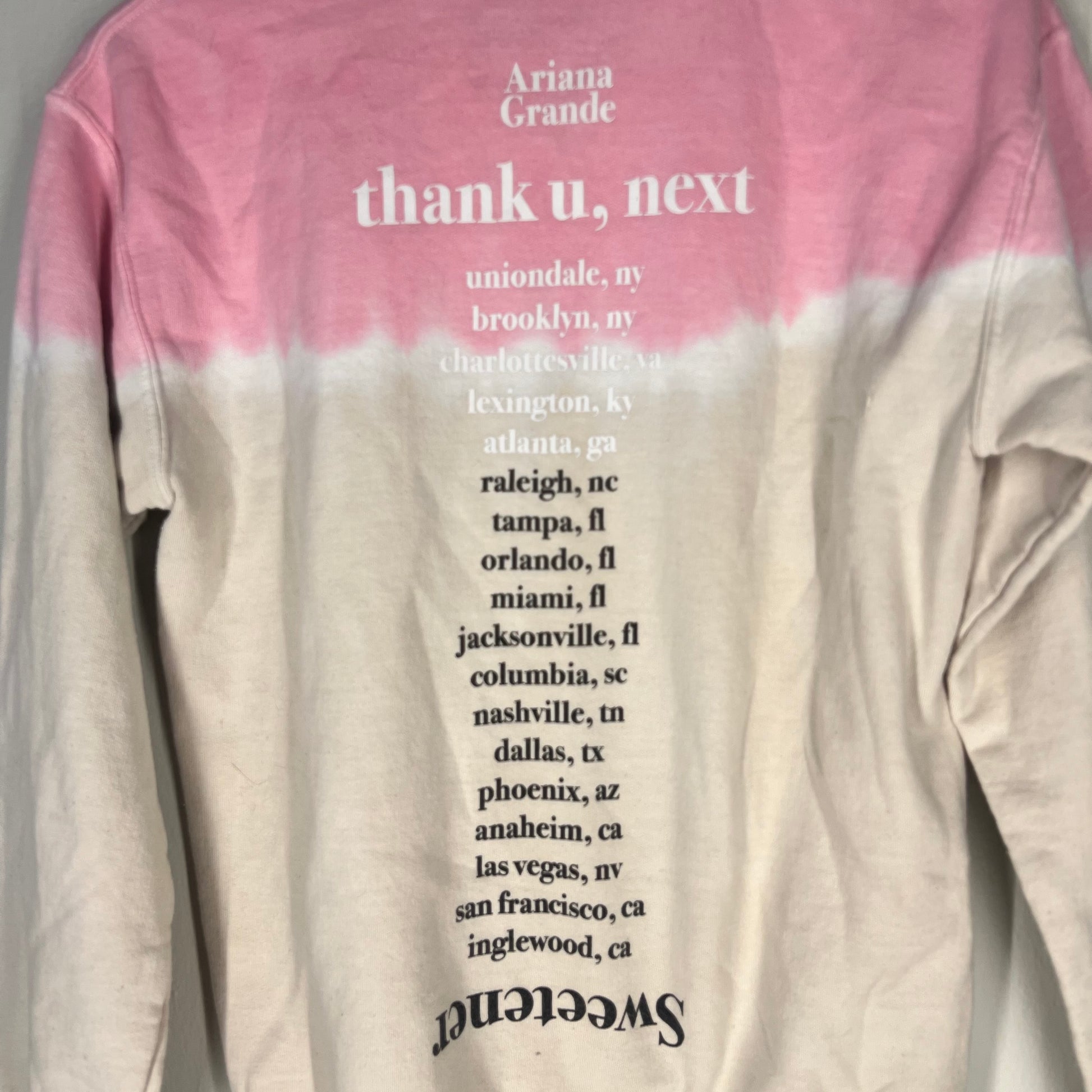 Close-up of “thank u, next” back print with listed cities