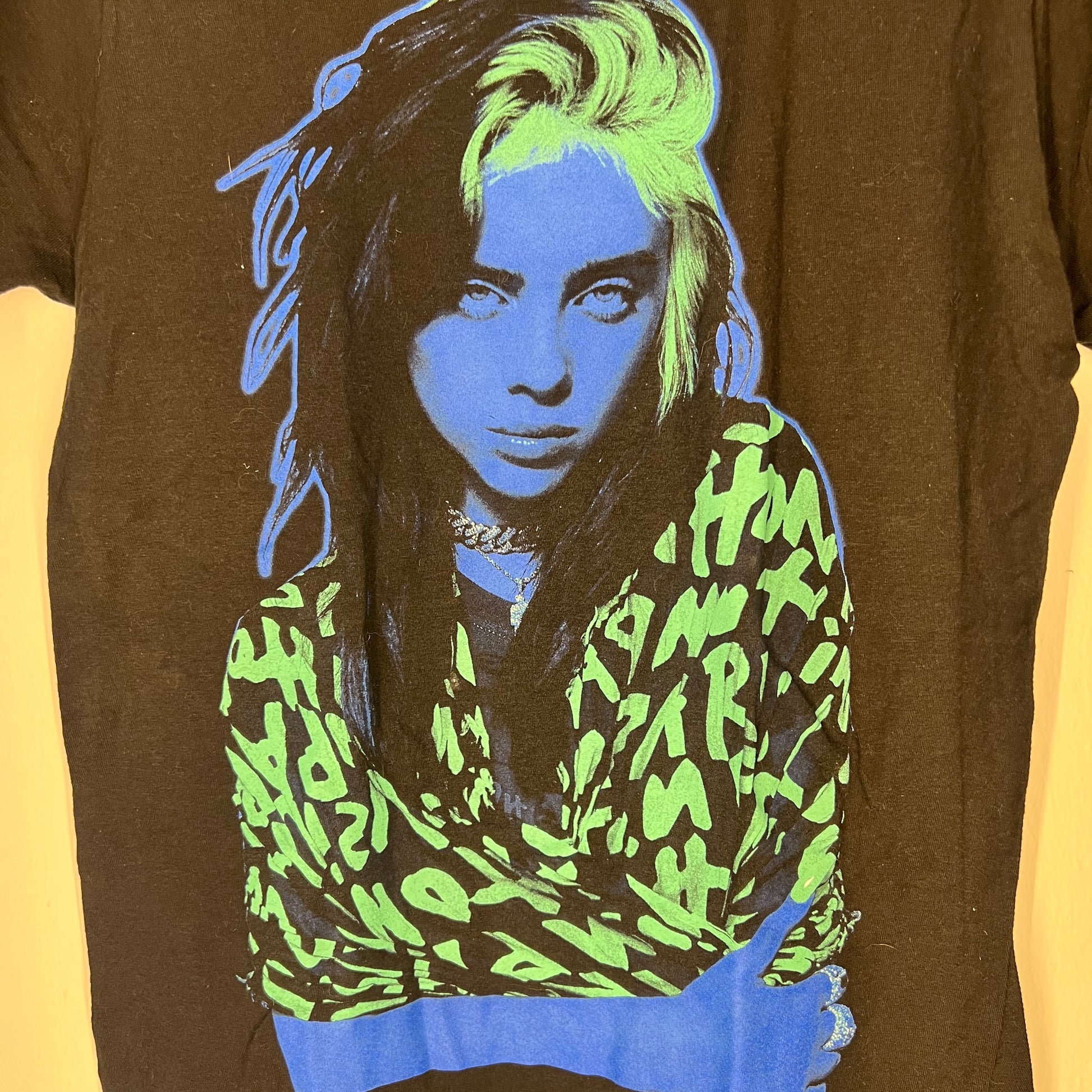 Close-up of Billie Eilish neon green and blue graphic print
