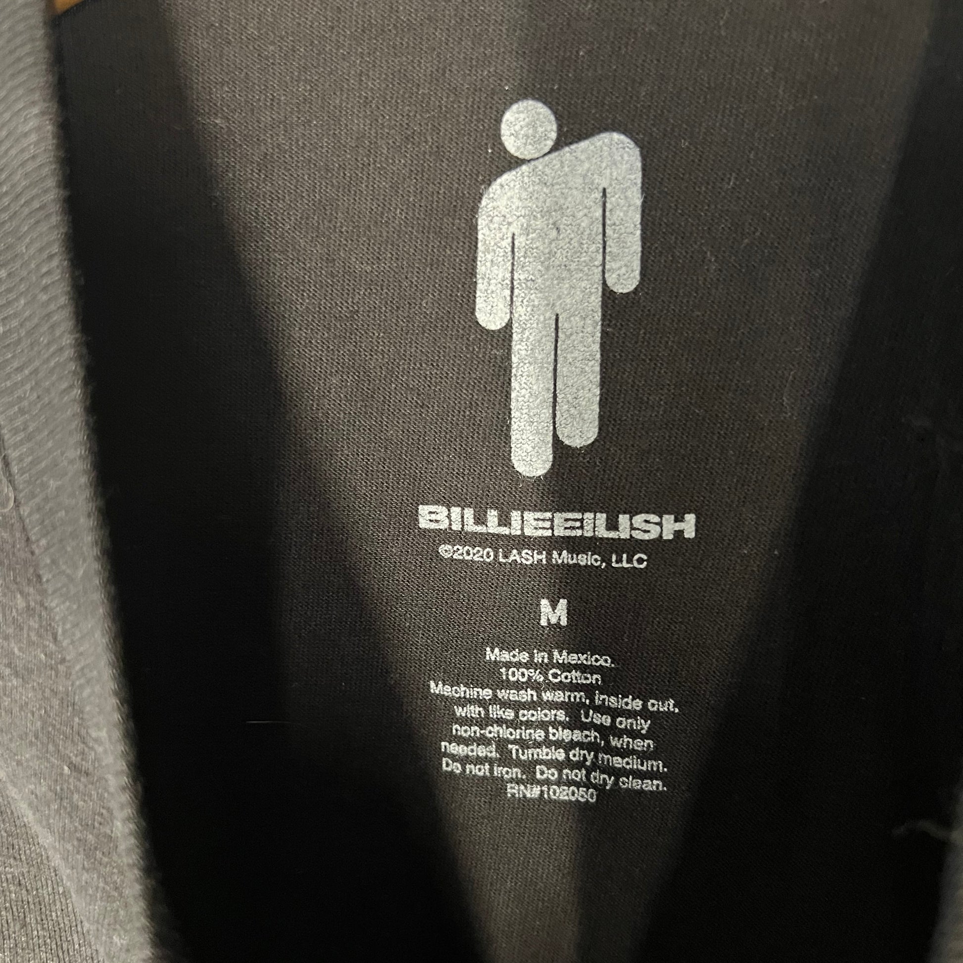Interior label showing Billie Eilish logo and sizing details (Size M)