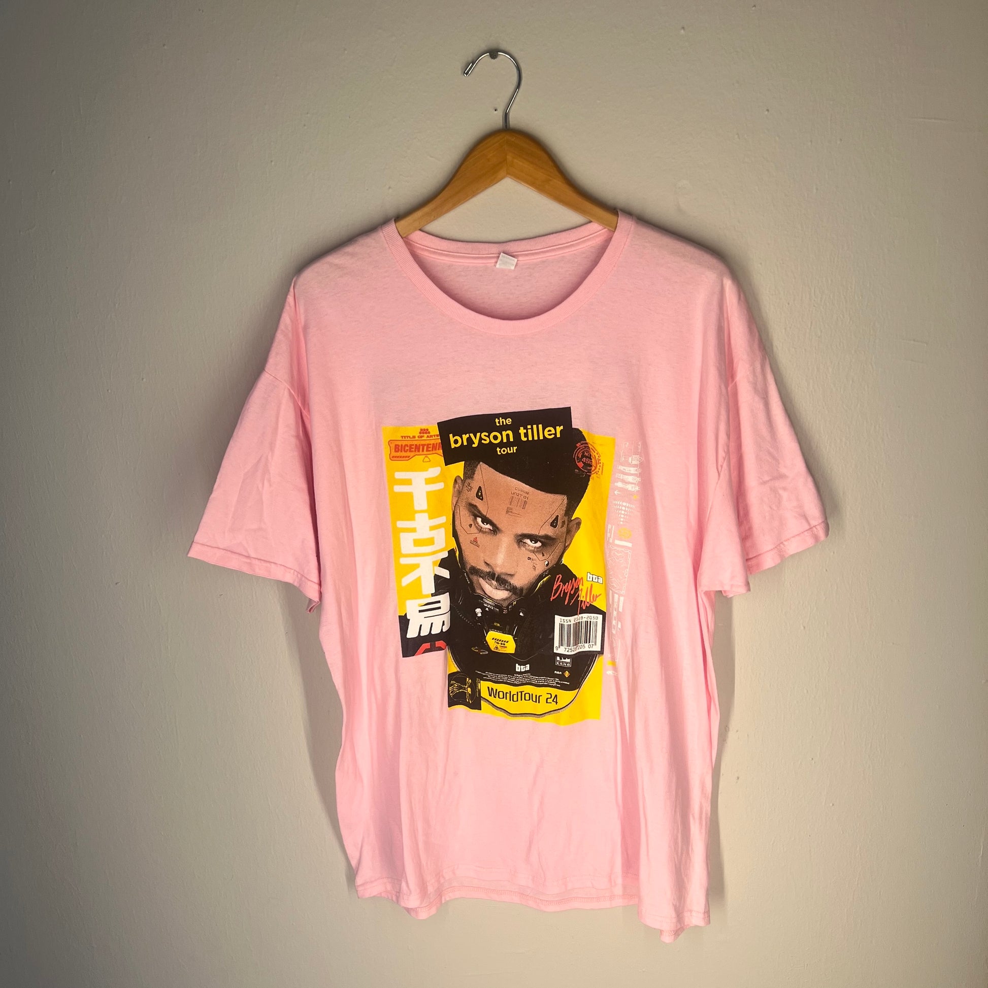 Front view of pink Bryson Tiller World Tour 24 graphic T‑shirt on hanger