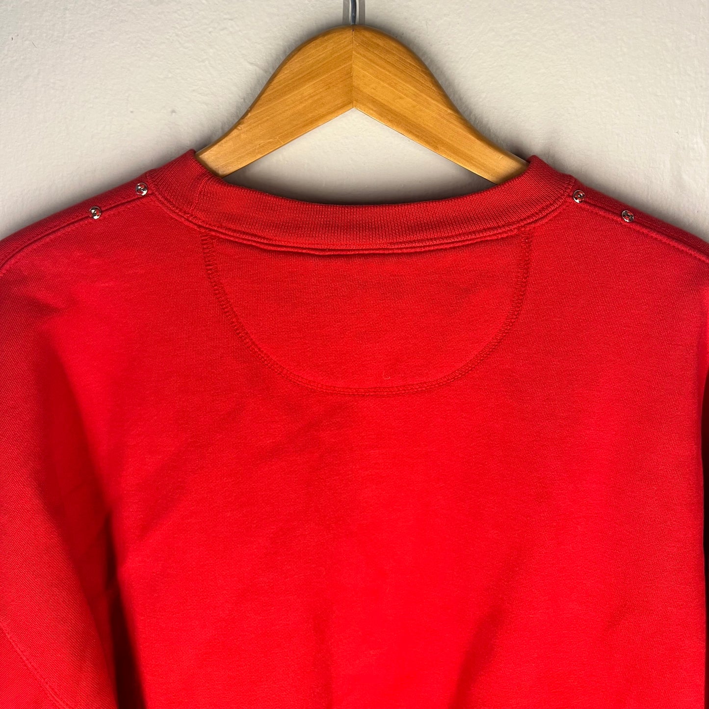 Close-up of back neckline and shoulder stud details