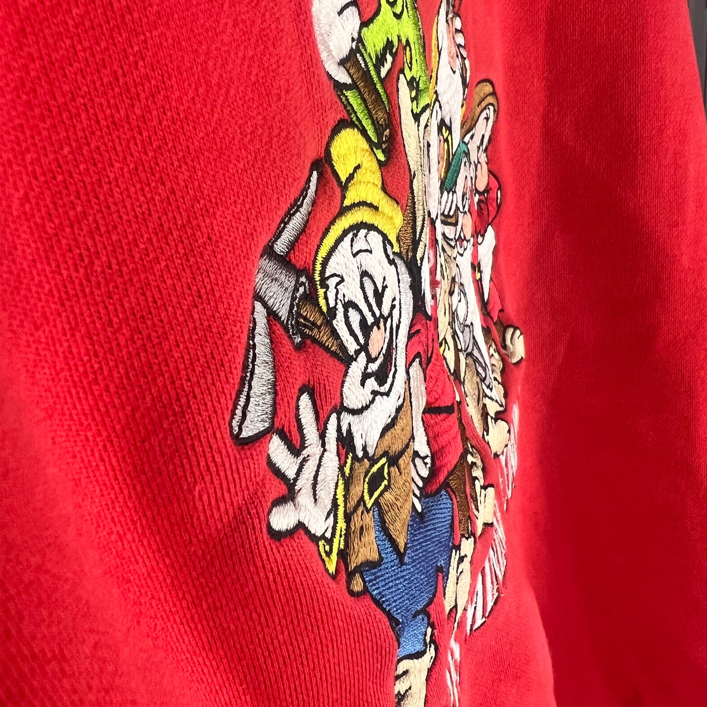 Angled view of textured embroidery detail on Dwarfs graphic