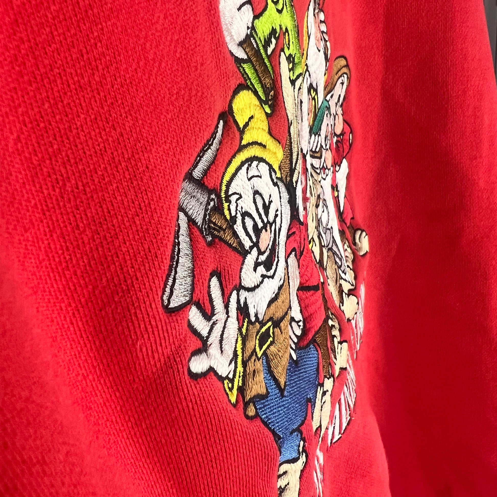 Angled view of textured embroidery detail on Dwarfs graphic