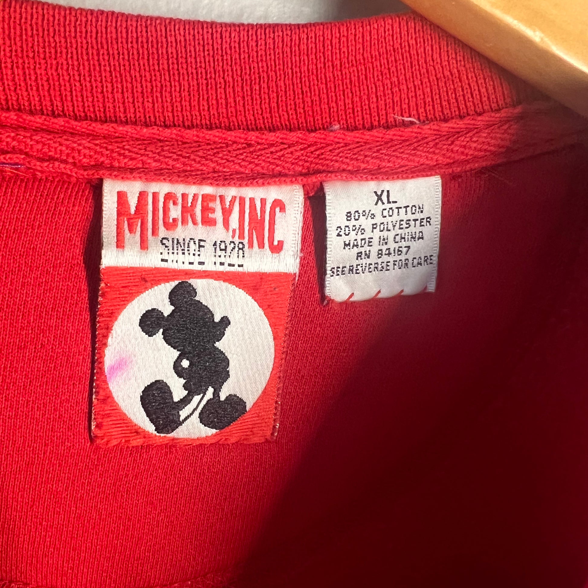 Mickey Inc woven neck tag with size XL and fabric content