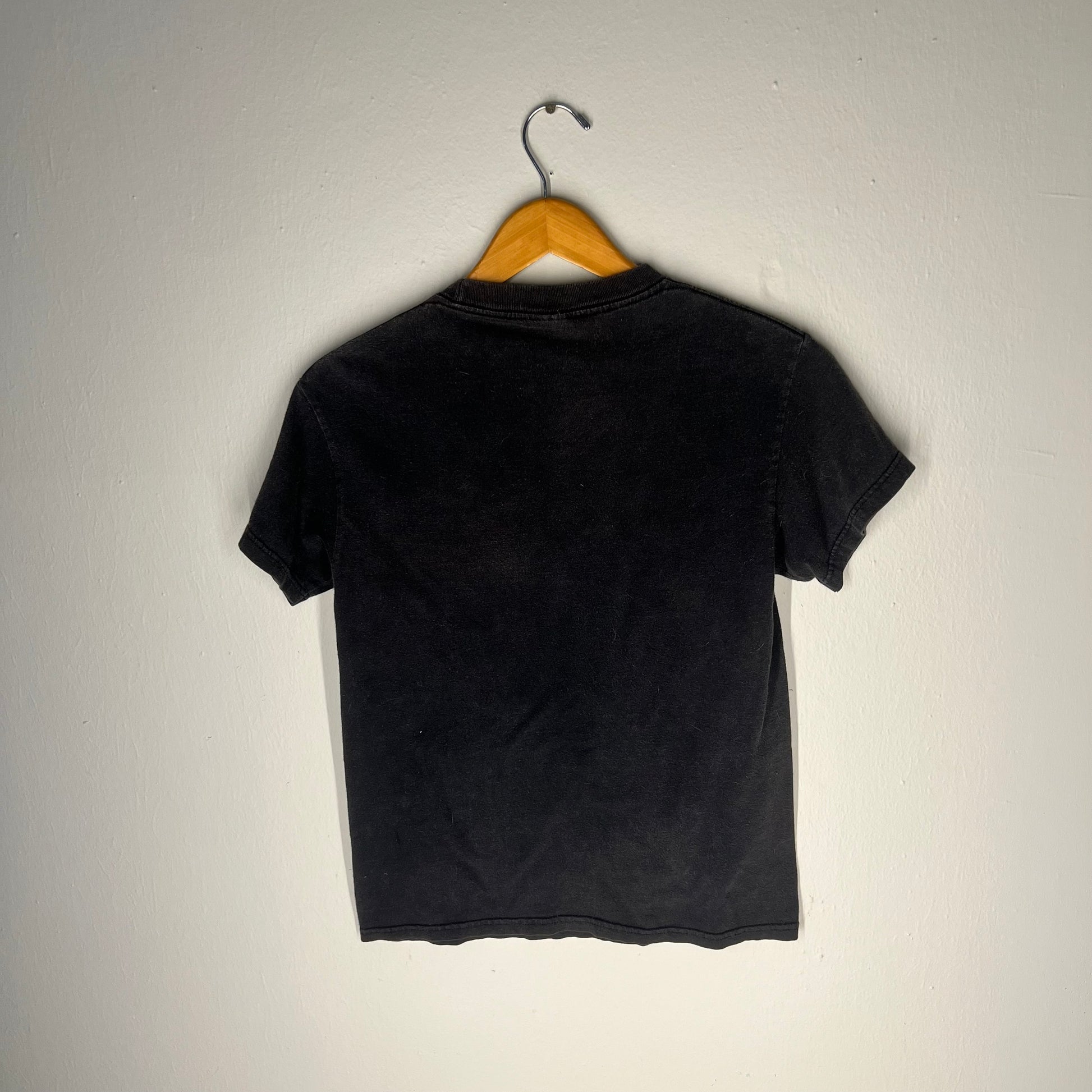 Back side of AC/DC vintage t-shirt showing blank faded black cotton