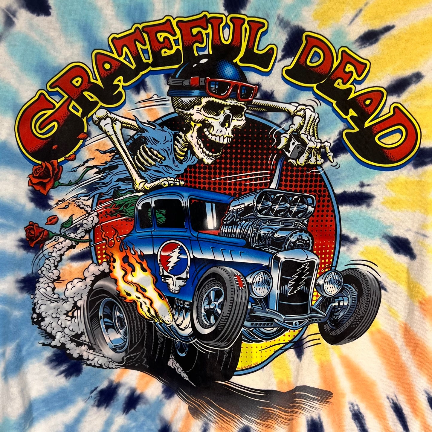 Close-up of Grateful Dead graphic featuring skeleton driving hot rod with flames