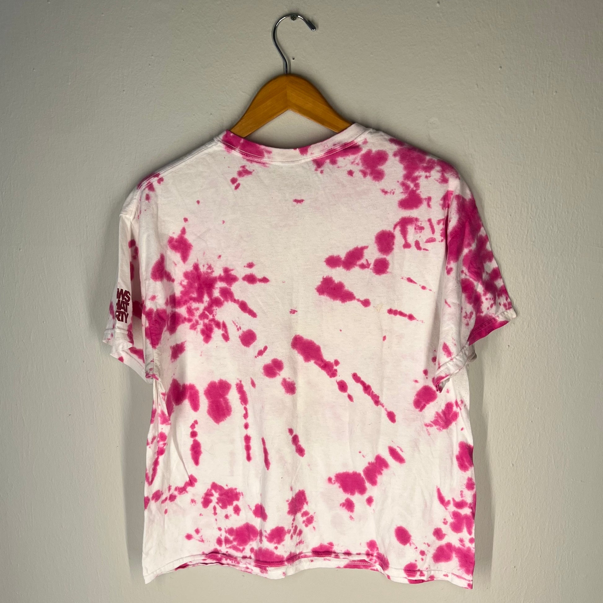 Back view of KAWS x Brooklyn Museum tee with pink/white tie‑dye pattern