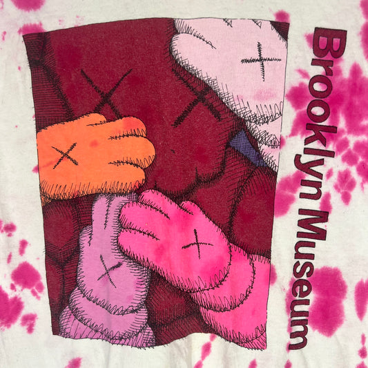 Close‑up of KAWS Companion hands artwork with Brooklyn Museum text