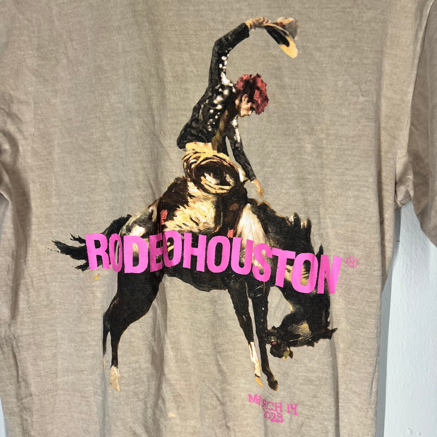 Close-up of bucking bronco and RodeoHouston print on MGK shirt
