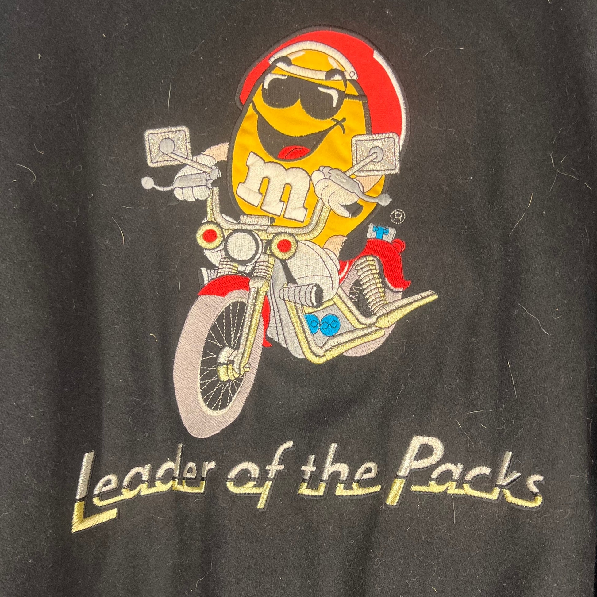 Close-up of large Yellow M&M motorcycle embroidery with “Leader of the Packs” text