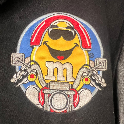 Close-up of Yellow M&M motorcycle embroidery on front chest
