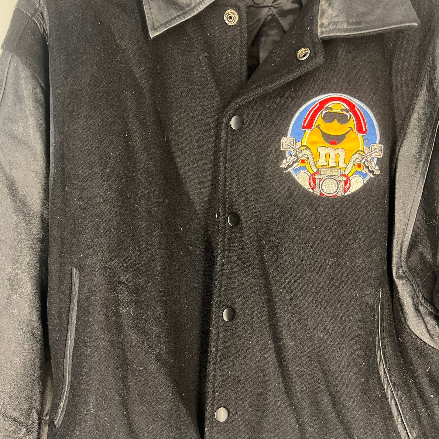 Close-up of Yellow M&M motorcycle embroidery on front chest
