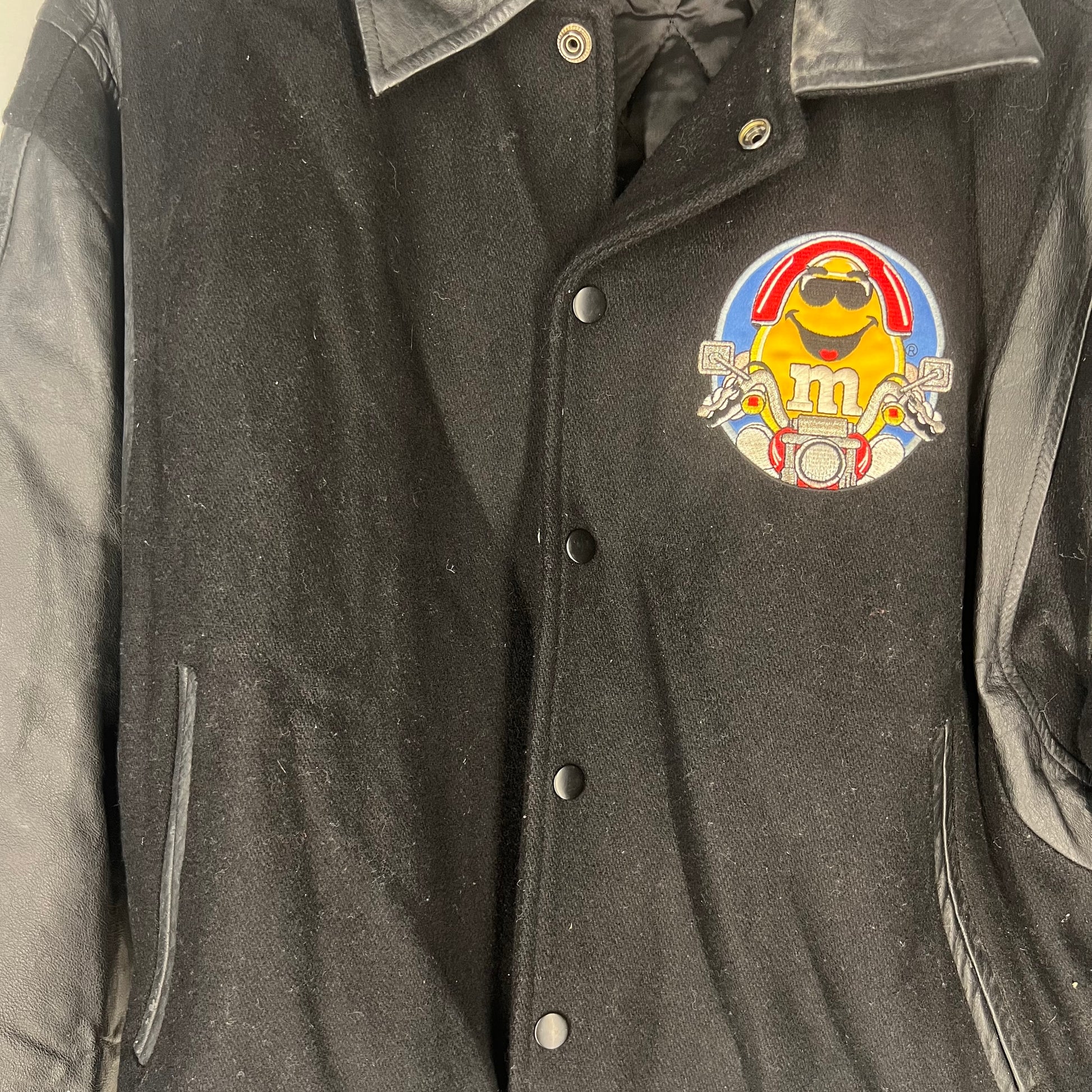 Close-up of Yellow M&M motorcycle embroidery on front chest