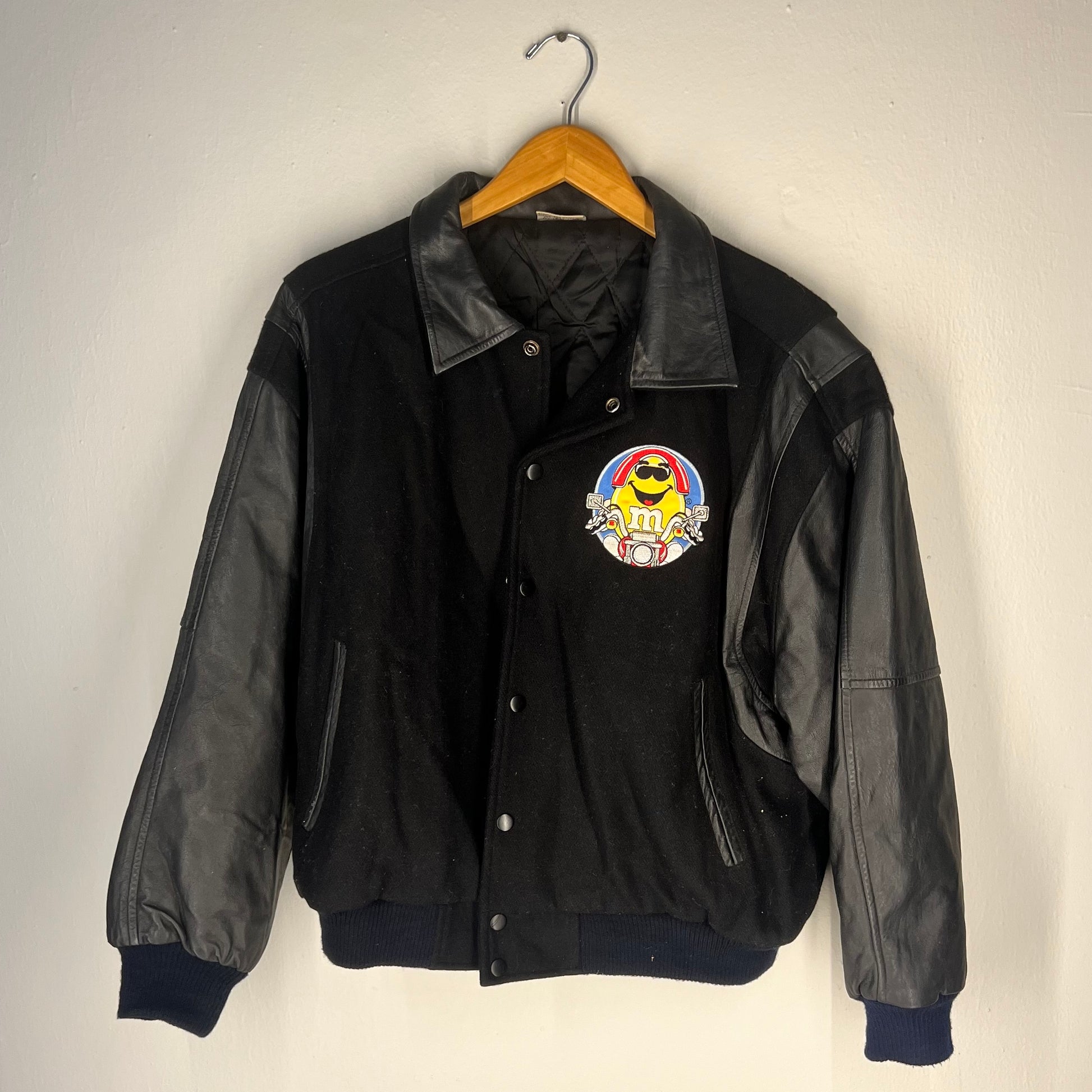 Front view of Vintage 1994 M&M’s varsity jacket (black, Medium)