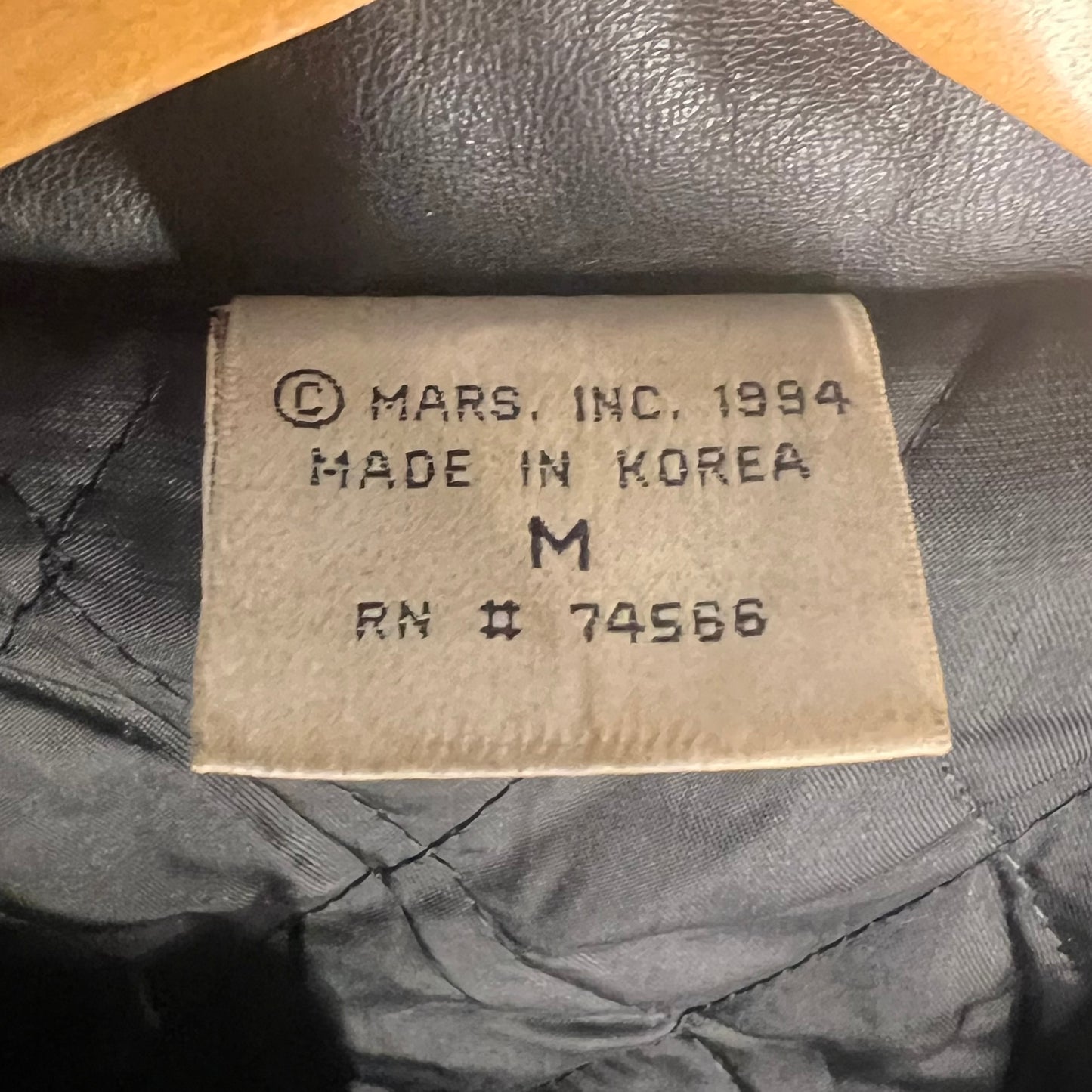 Inside neck tag showing © Mars Inc. 1994, Made in Korea, size Medium