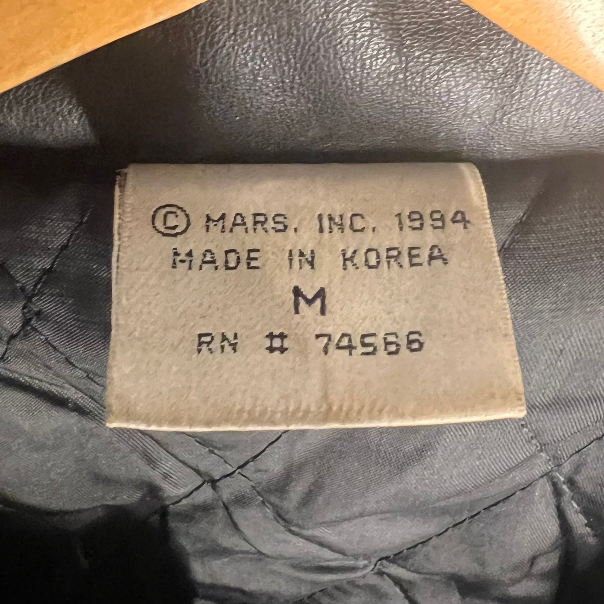 Inside neck tag showing © Mars Inc. 1994, Made in Korea, size Medium
