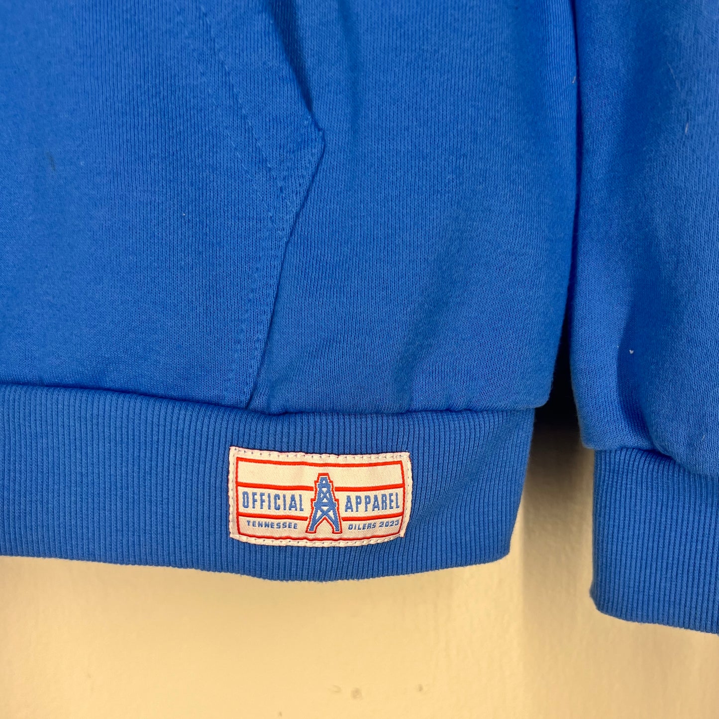 Close-up of “Official Oilers Apparel” woven hem patch