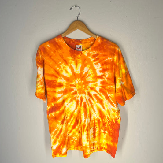 Front view of orange and yellow tie-dye T-shirt with spiral burst pattern