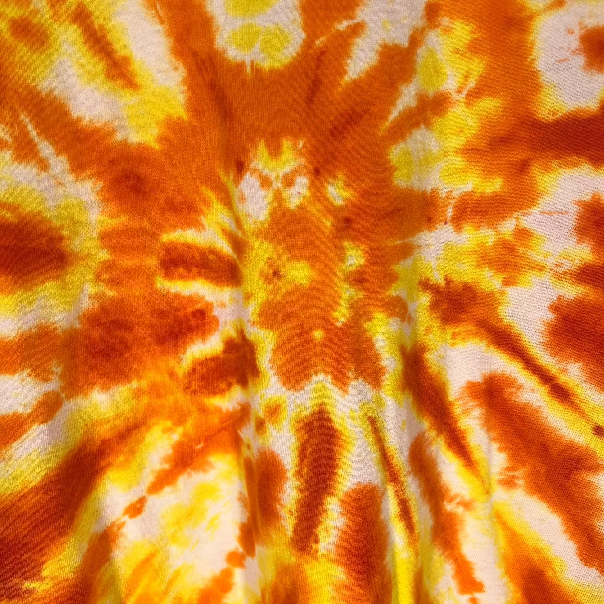 Detailed close-up of back orange and yellow tie-dye design
