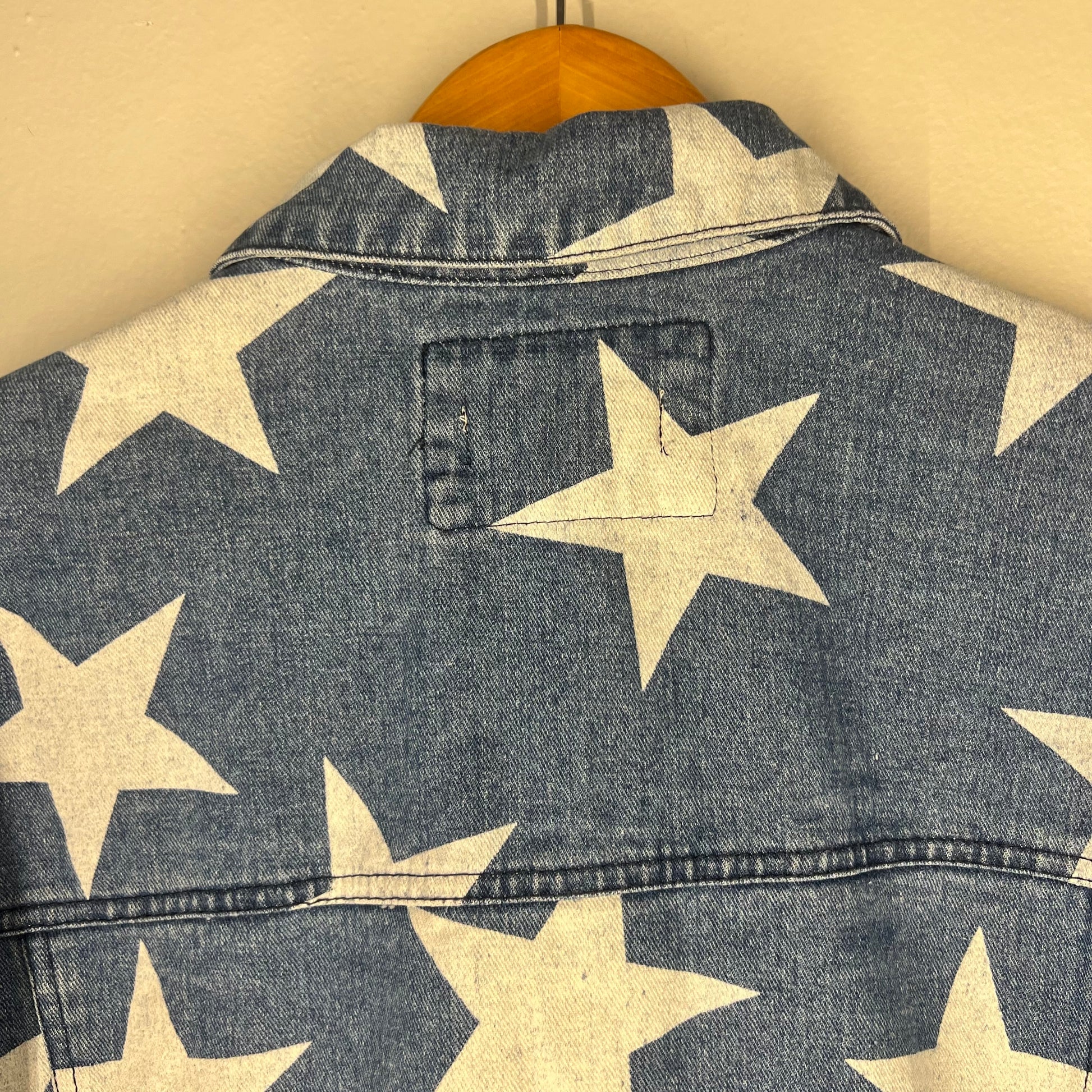 Close-up of back collar and star print at neckline