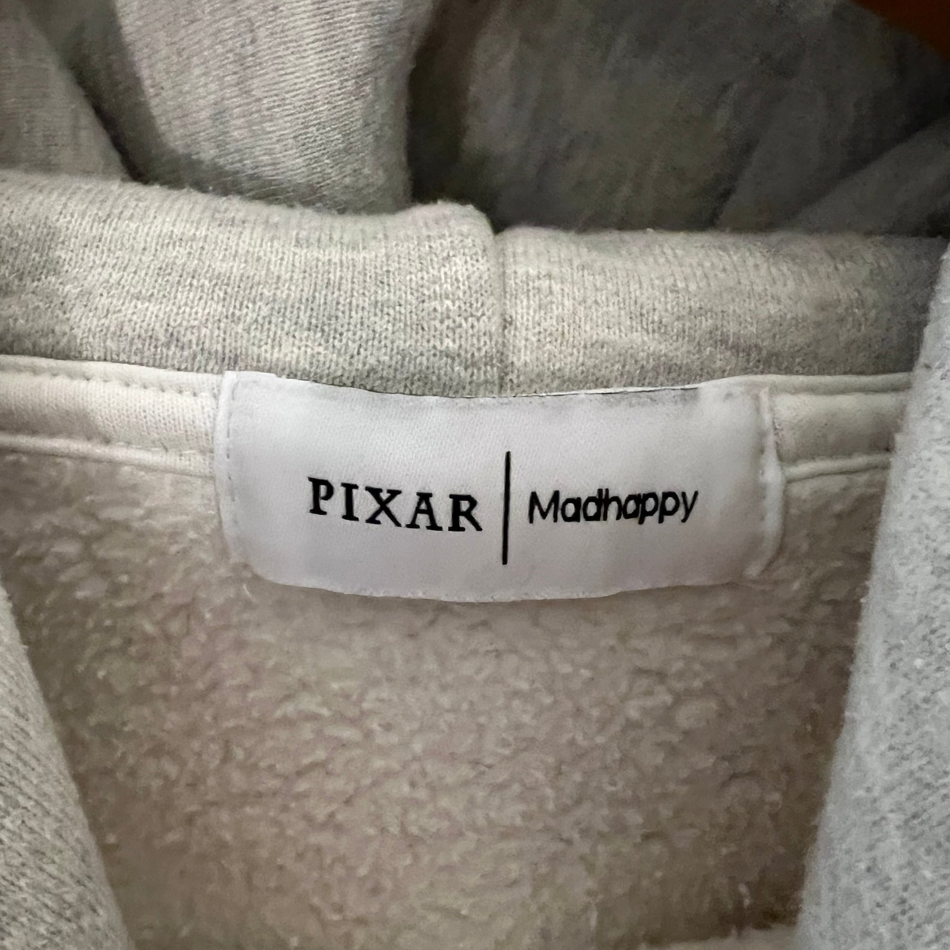 Pixar and Madhappy branding tag inside hoodie