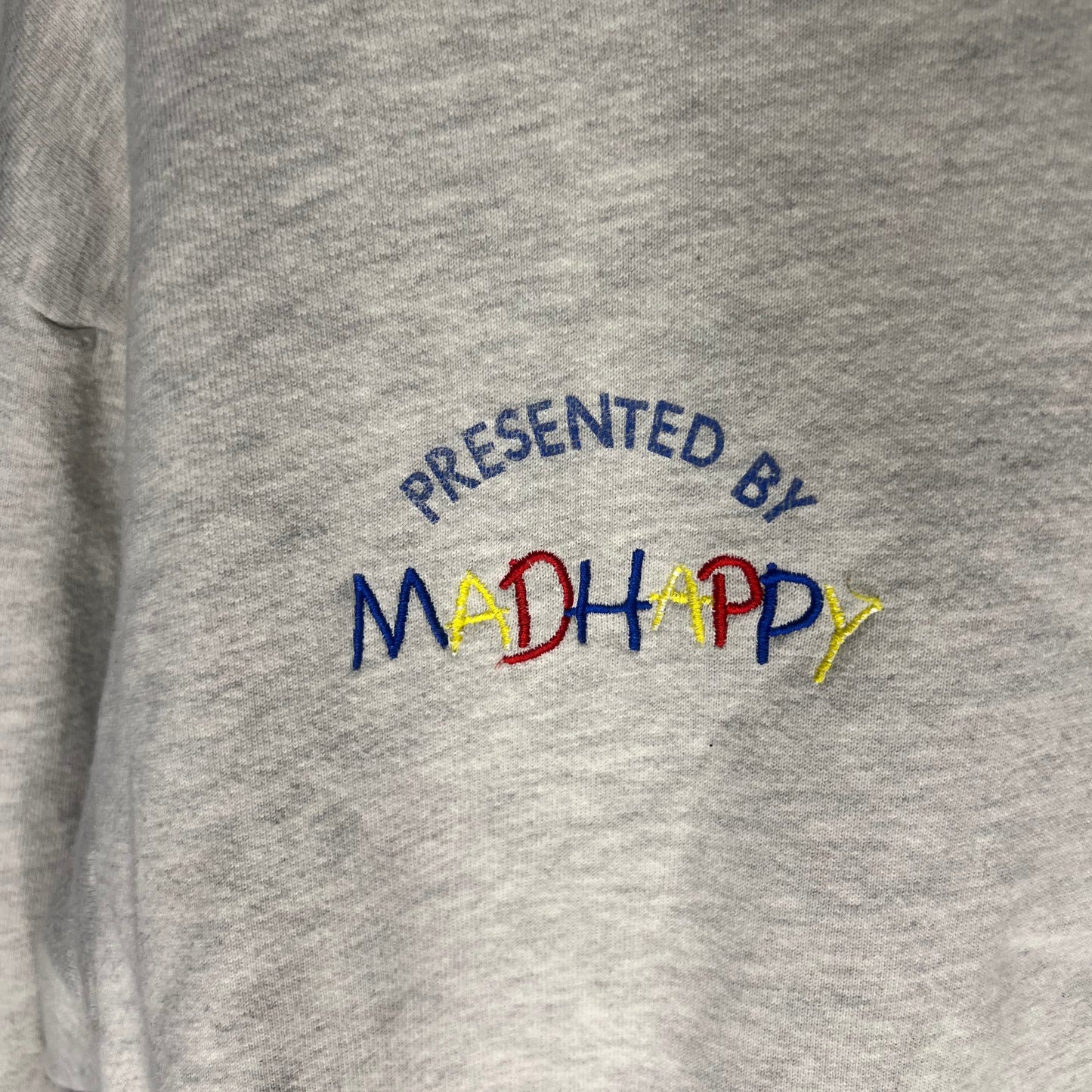 Close-up of 'Presented by Madhappy' embroidery on hoodie