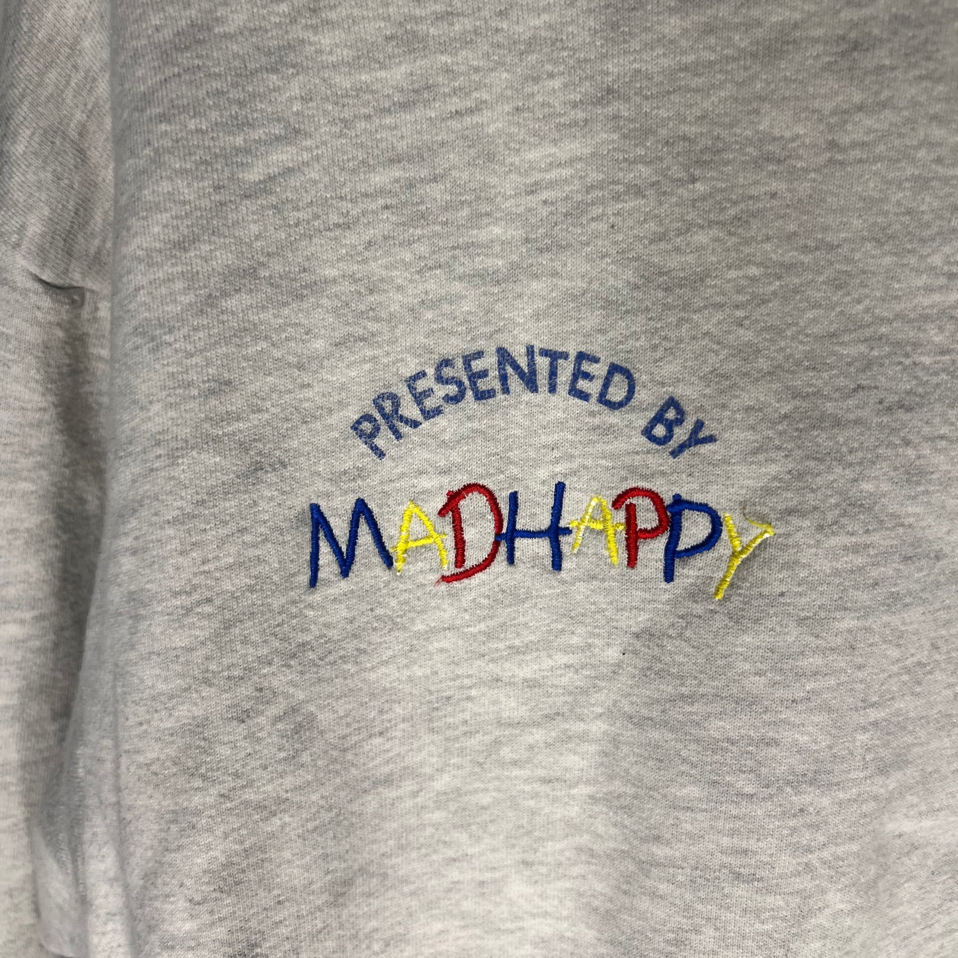 Close-up of 'Presented by Madhappy' embroidery on hoodie