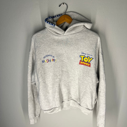 Front of grey Toy Story hoodie with Madhappy embroidery
