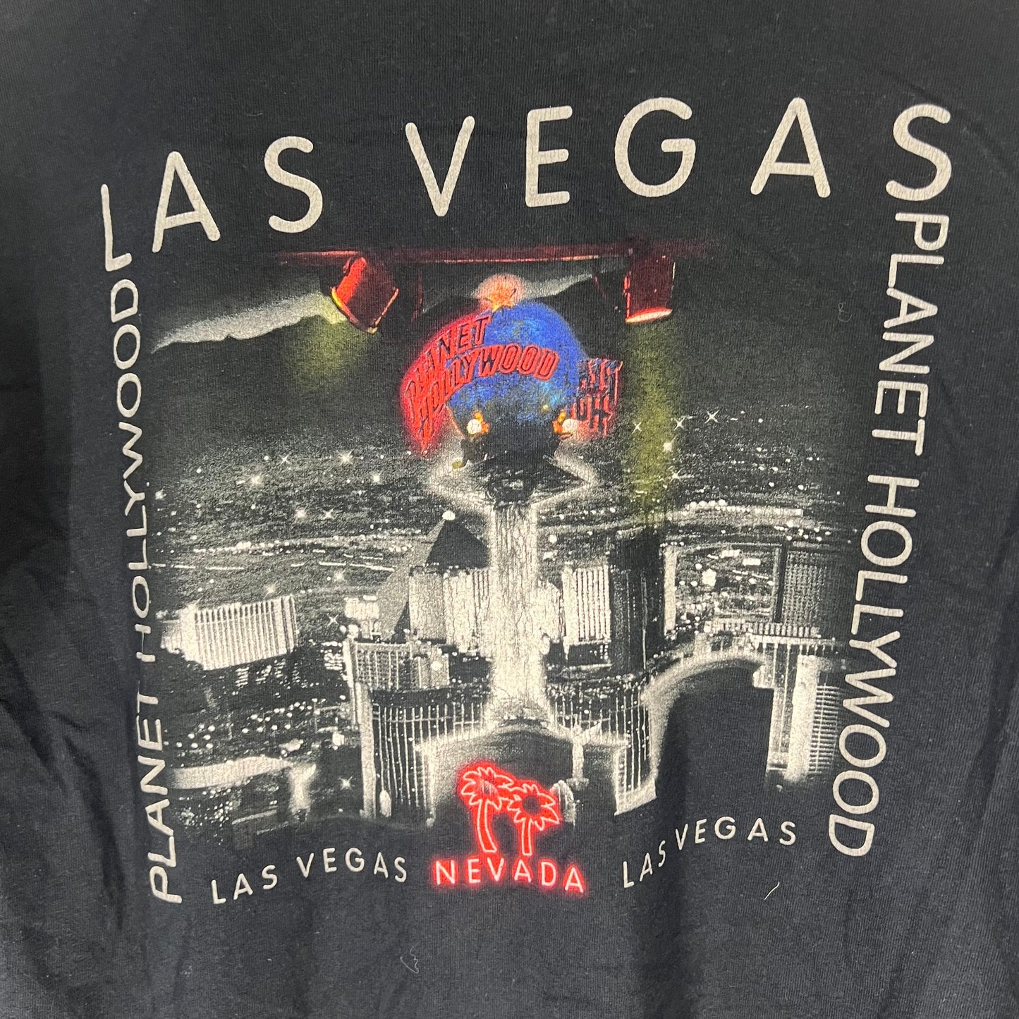 Close-up of large back print with Las Vegas skyline and neon accents.