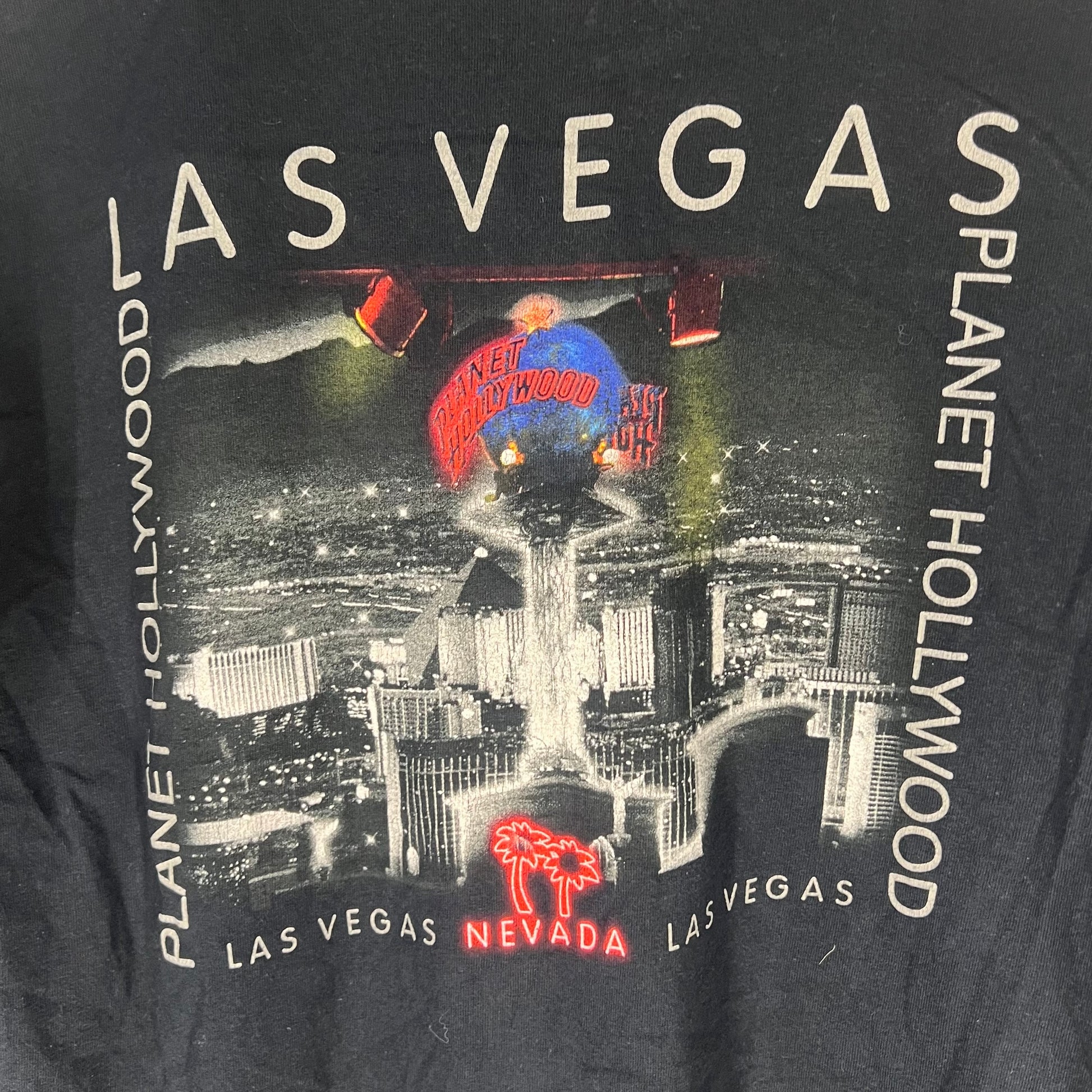Close-up of large back print with Las Vegas skyline and neon accents.