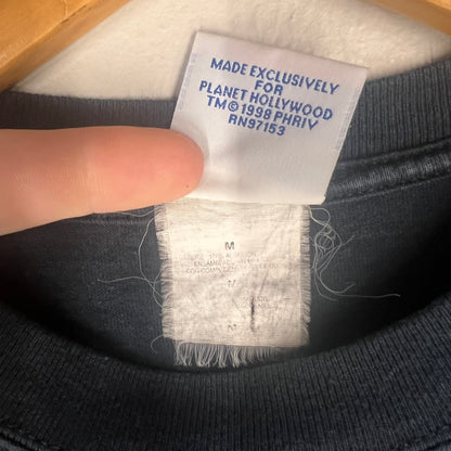 Interior tag showing size M, assembly details, and 1998 copyright.