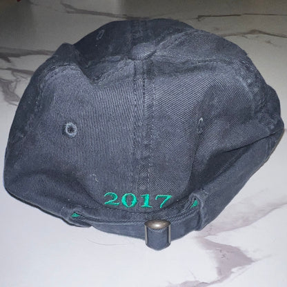 Back view with green "2017" embroidery and strapback closure