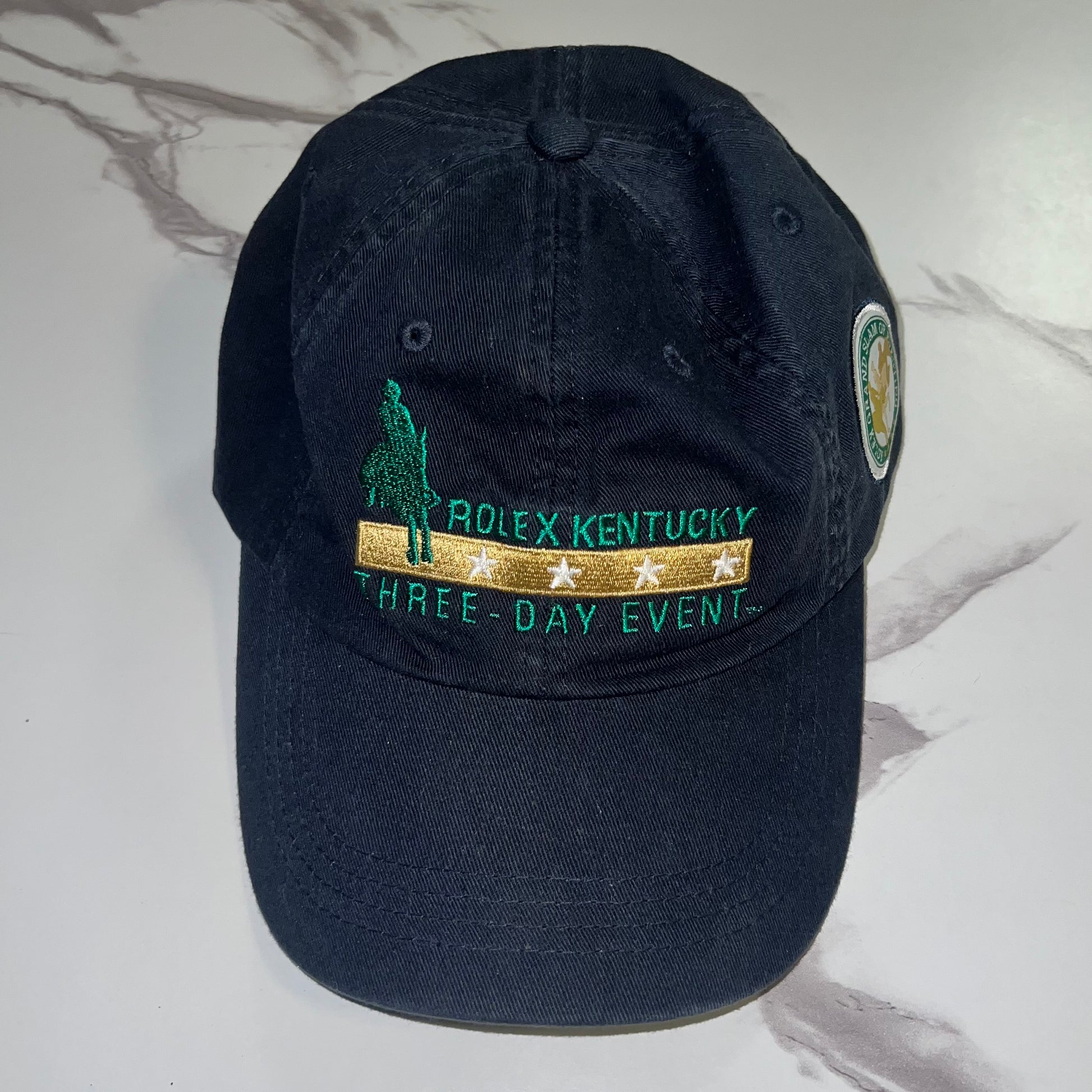 Front view of Rolex Kentucky Three-Day Event navy hat with embroidered rider and event text