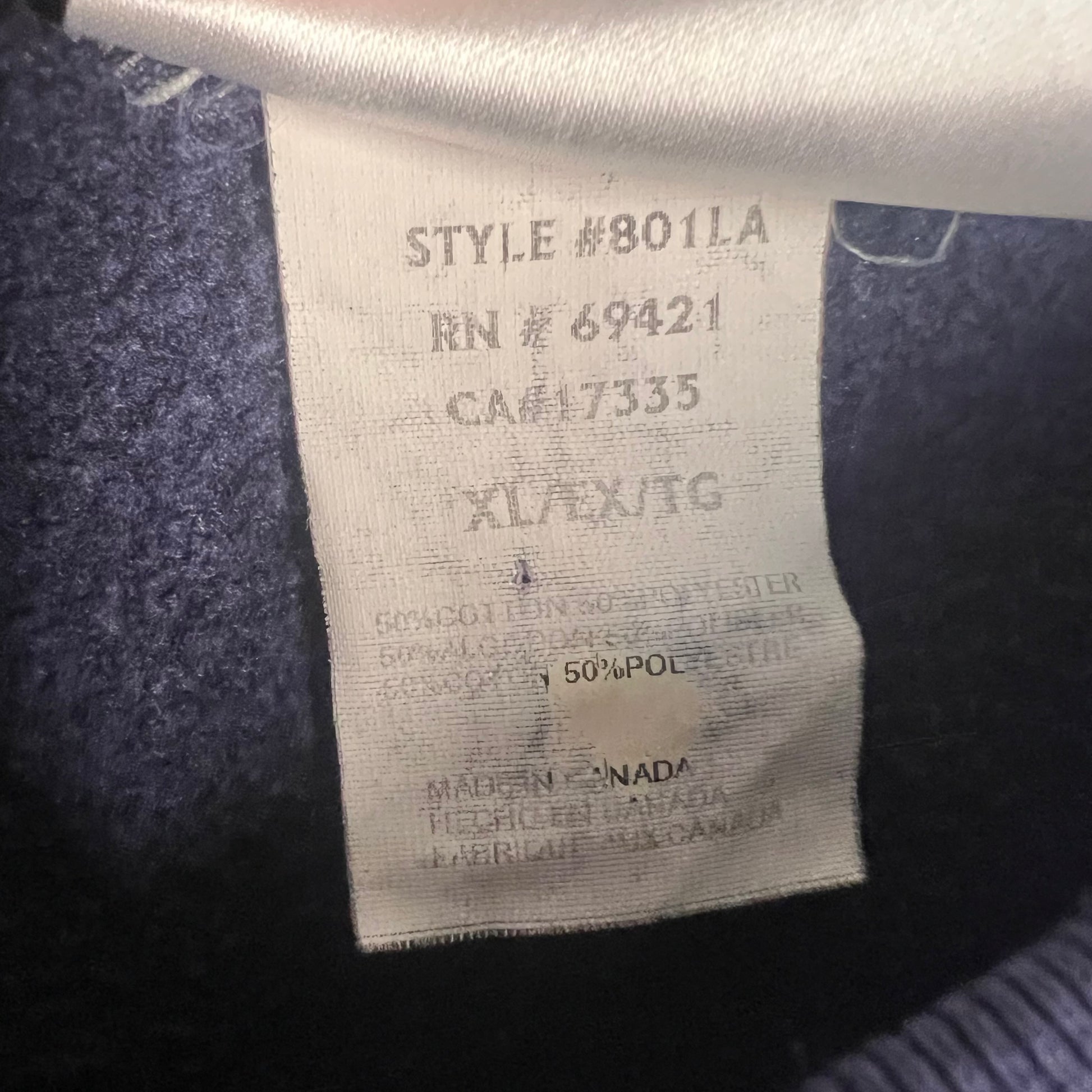 Interior tag showing fabric content, size XL, and origin (Made in Canada)